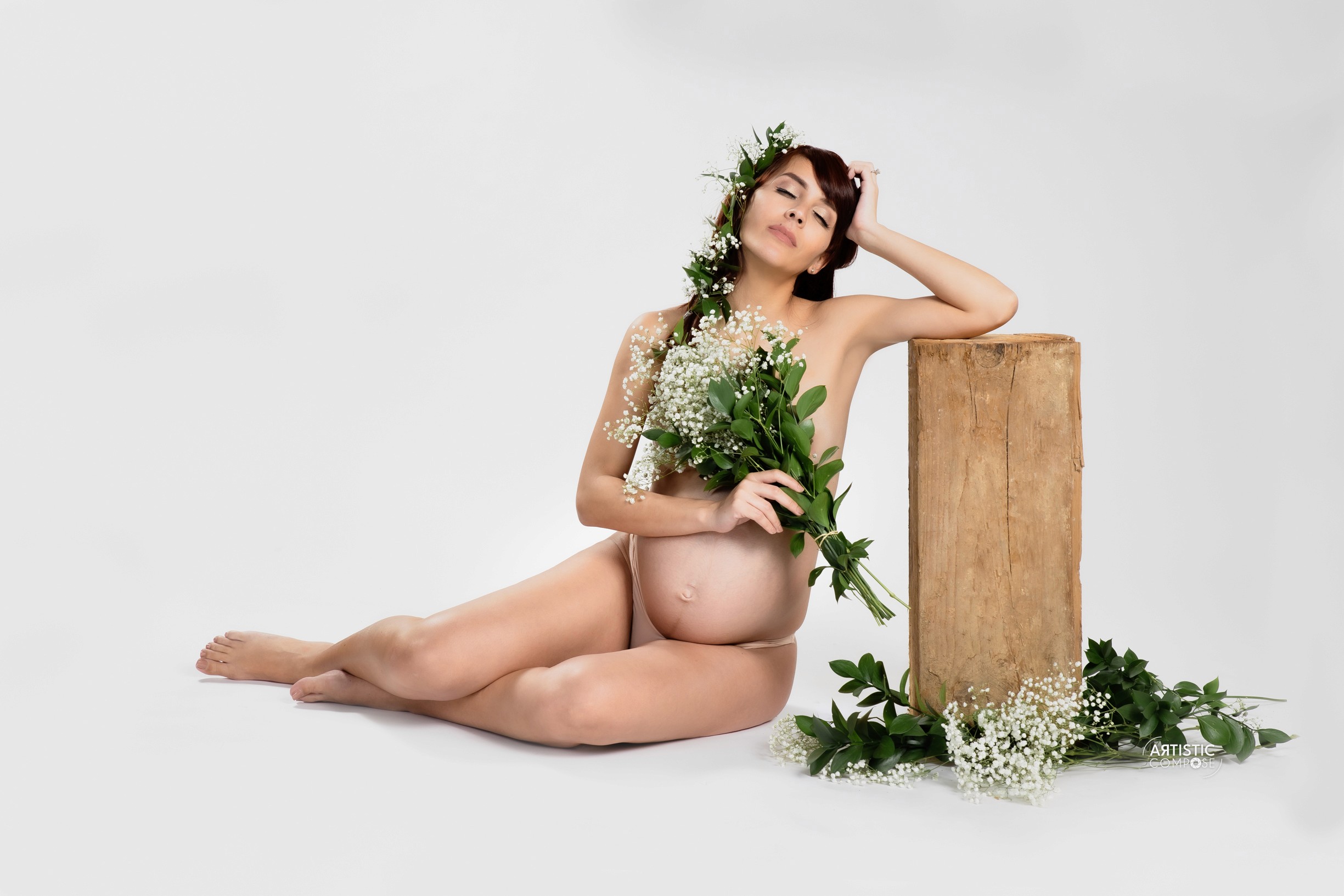 Three models standing in a wheat field, wearing beige suits.