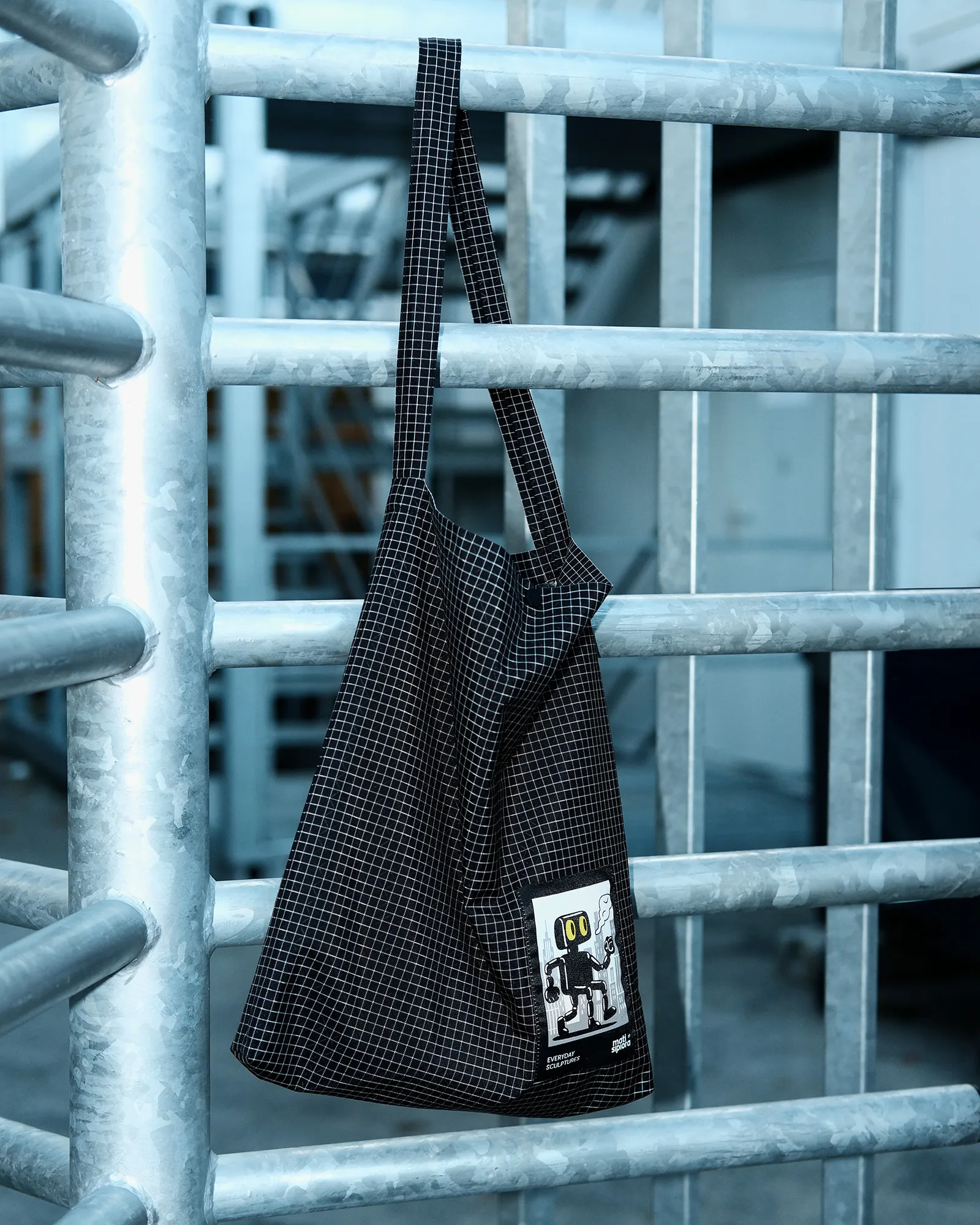 Tote bag hanging on metal structure