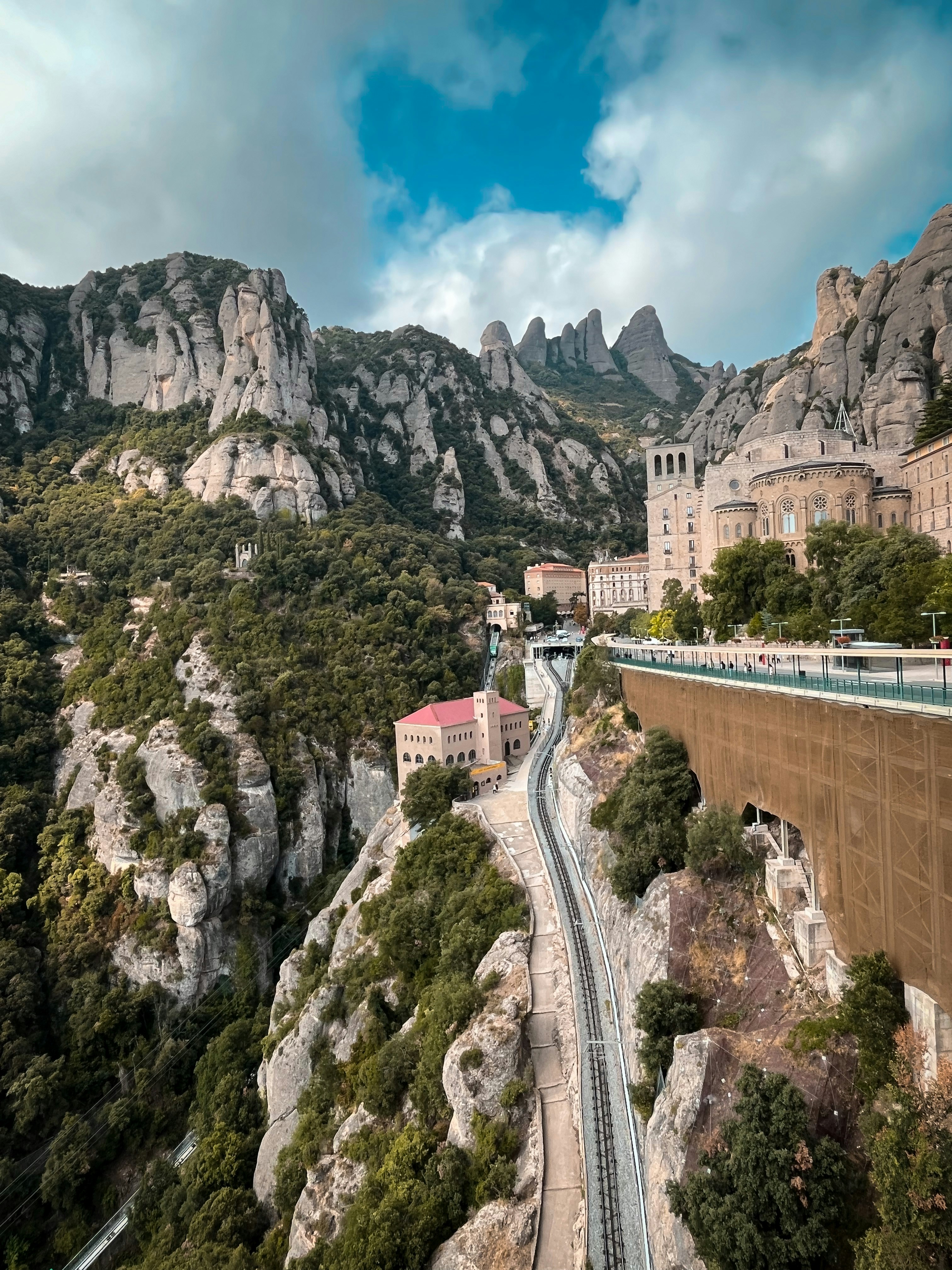 The side of the Montserrat Mountain, featuring the rack railway climbing up the side of the incline and ending at the Basilica.