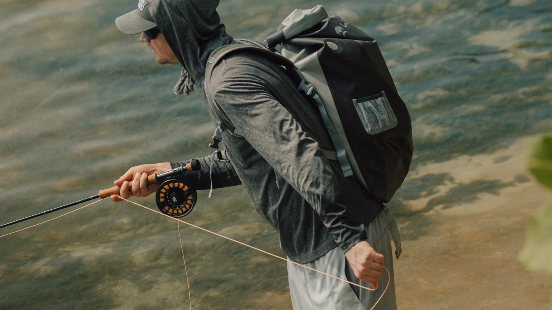 Angler holding a fly fishing rod on a flat in Belize