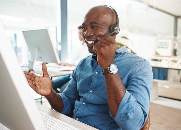 image of a man wearing a headset looking at a computer screen
