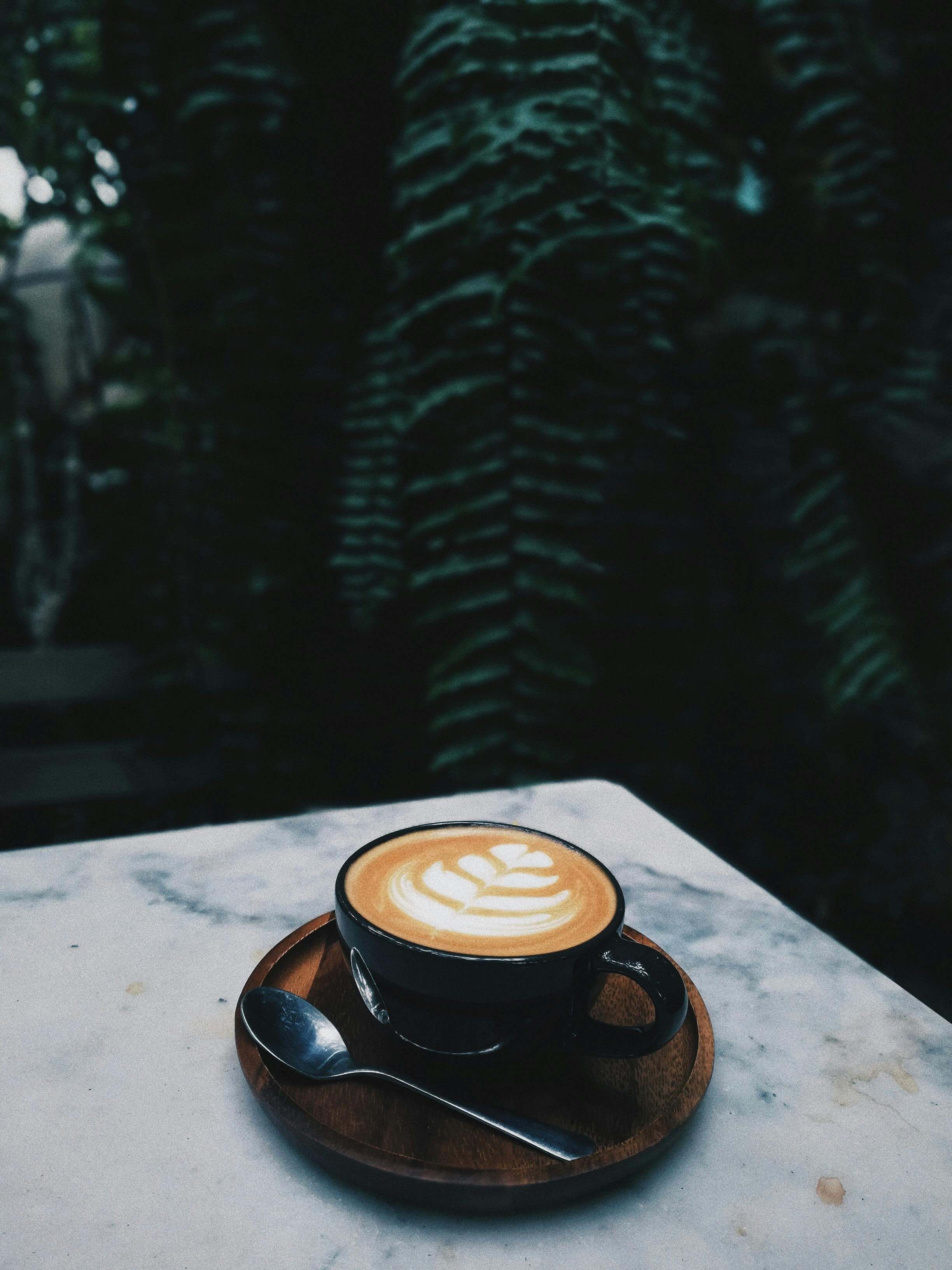 A latte in a black mug