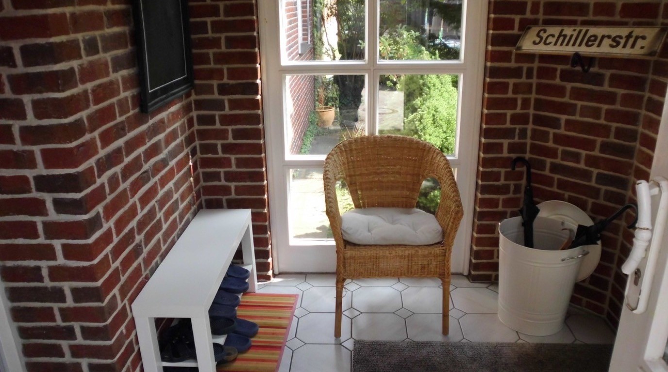 Eingangsbereich der Praxis AufWind in Uelzen mit Sitzgelegenheit und Blick in den Garten