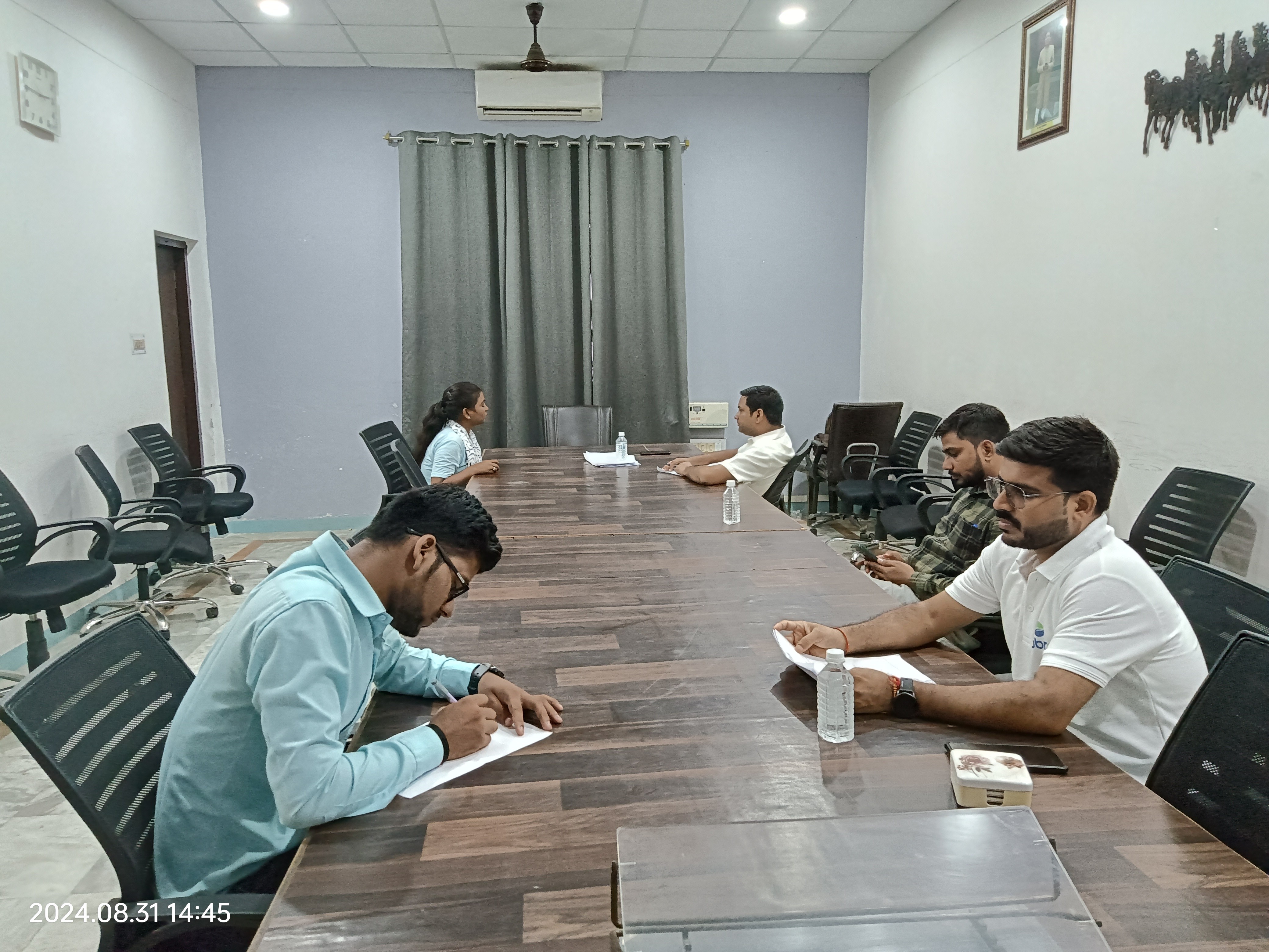 man standing in front of people sitting beside table with laptop computers