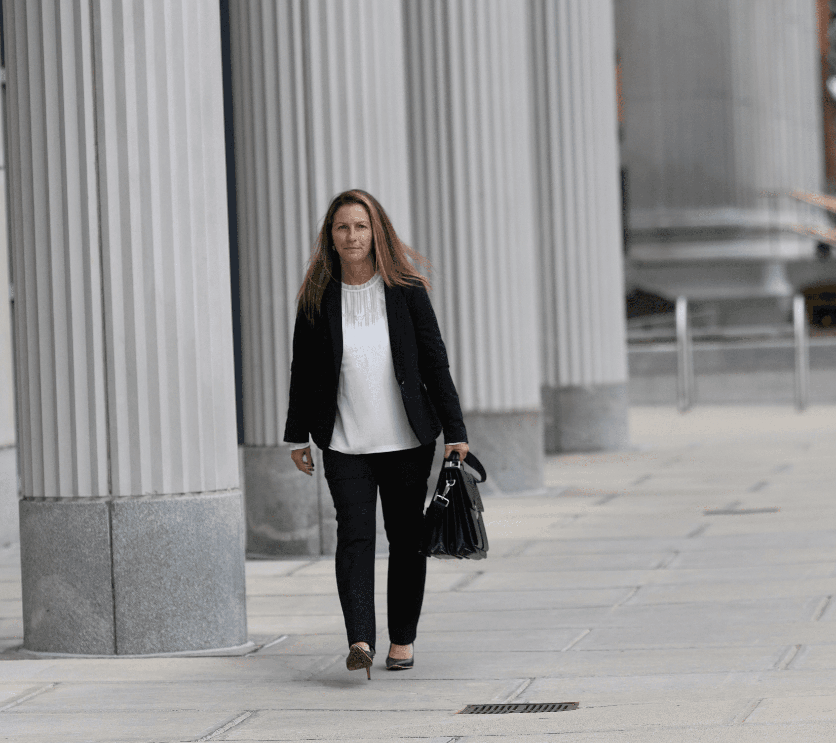Monique Boucher Lamb, Founding Attorney at Lamb & Lamb, P.C., walking outside the Essex County Probate and Family Court in Salem, MA