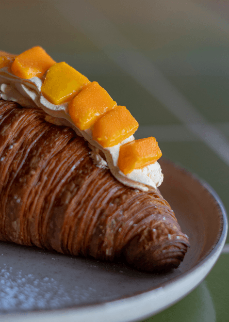 Croissant with Vanila Frosting and Mango Pieces on Top