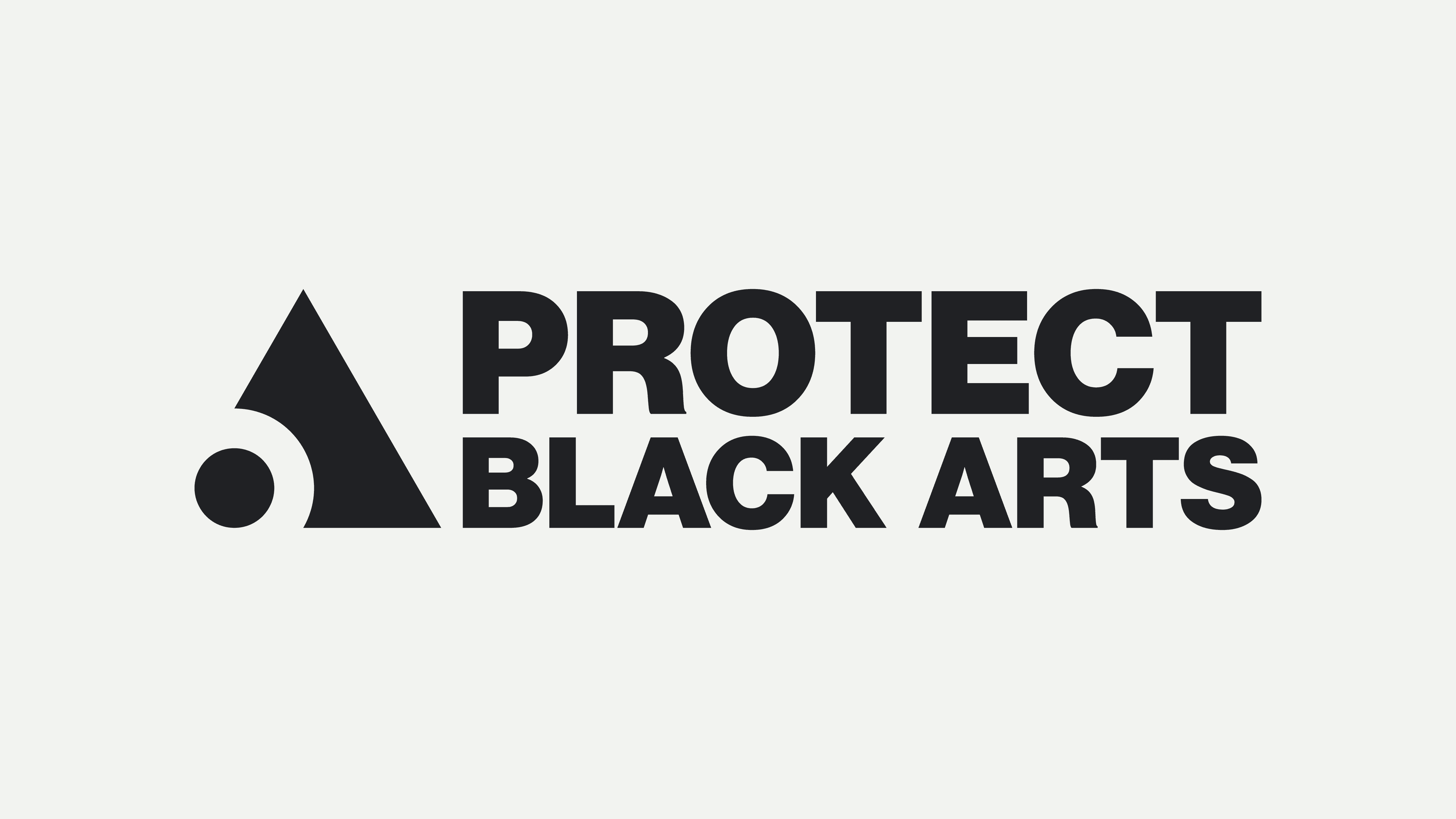 woman in black blazer covering her face with her hand