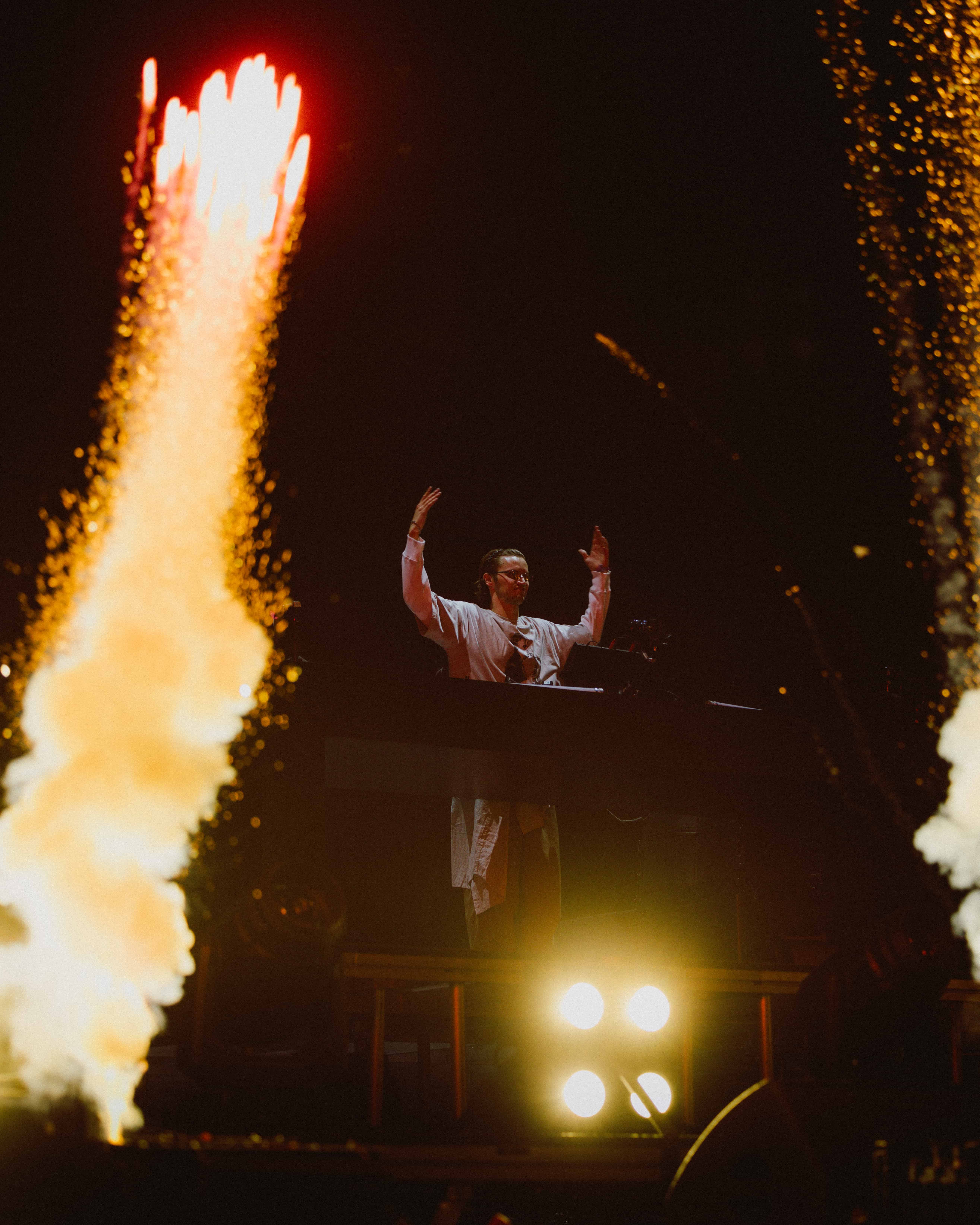 MAU P performing live at Coachella 2025 with pyrotechnics erupting on stage, captured by A World Away creative director Brandon Densley
