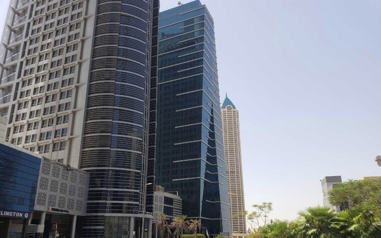 View of high-rise commercial towers in a business hub, managed by leading real estate agents for clients.