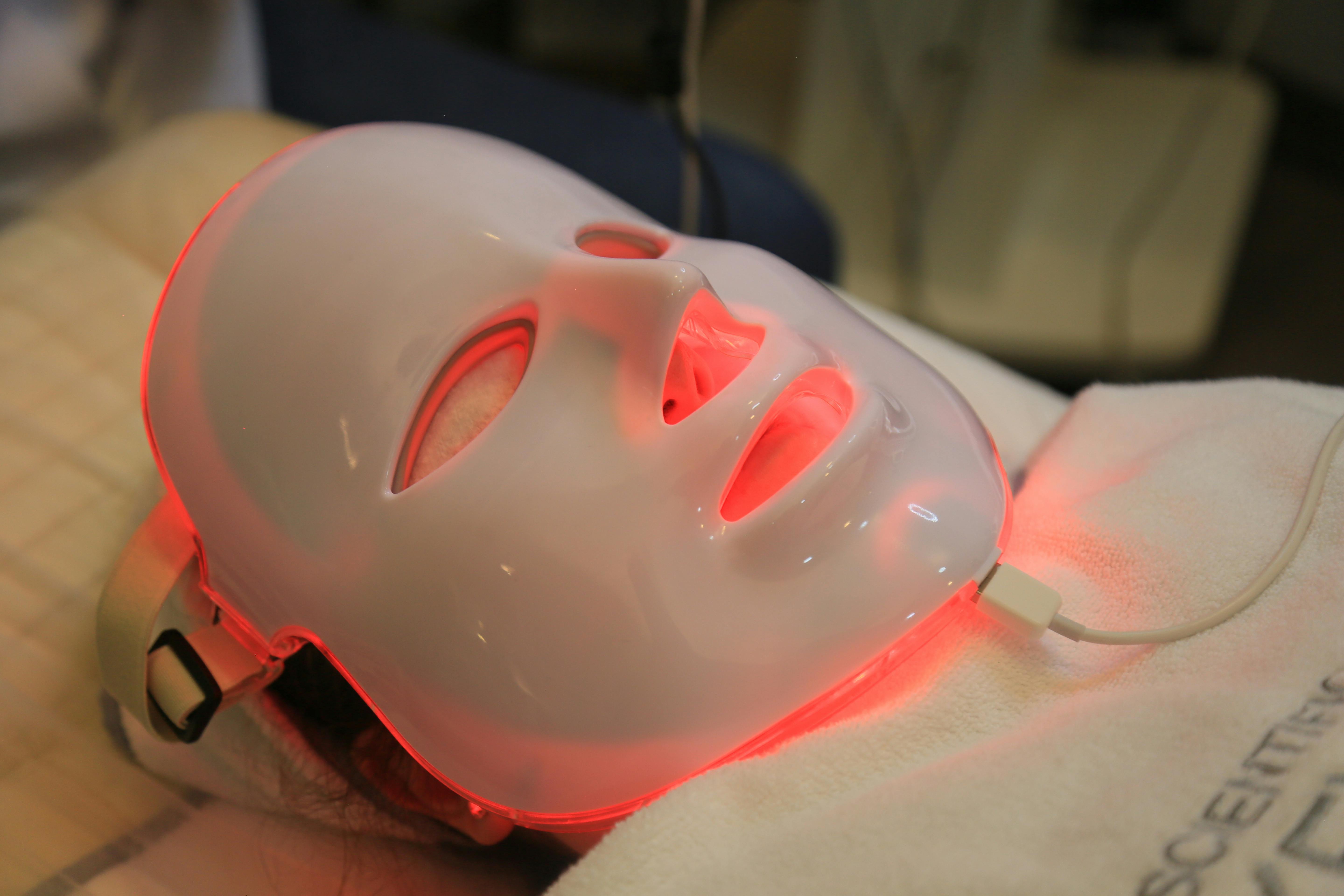 Best red light therapy masks - woman wearing a full face LED mask