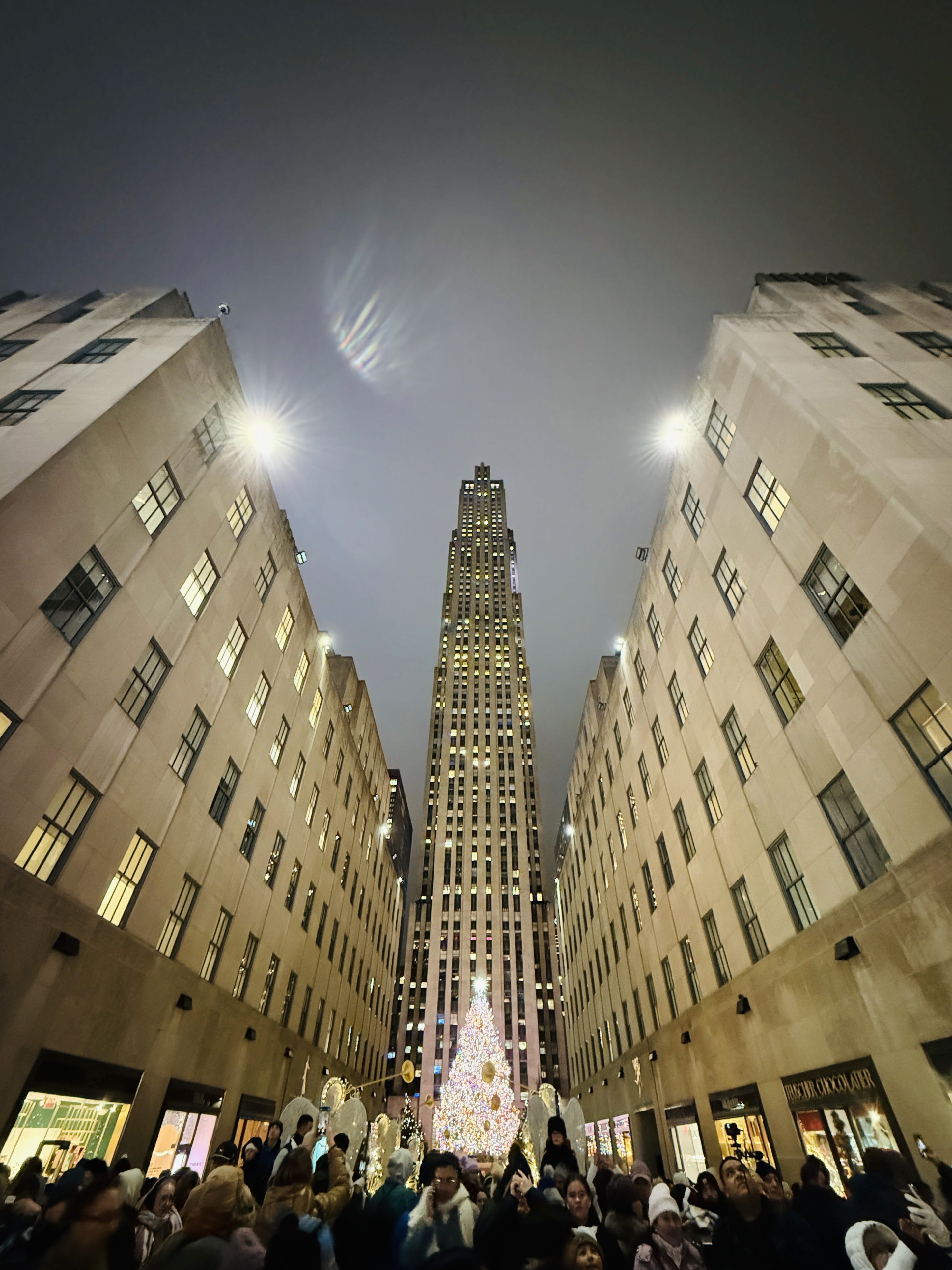 Close-up of two hands gently clasped, one wearing a sparkling engagement ring. The soft lighting and pastel nails evoke a sense of romance and intimacy.