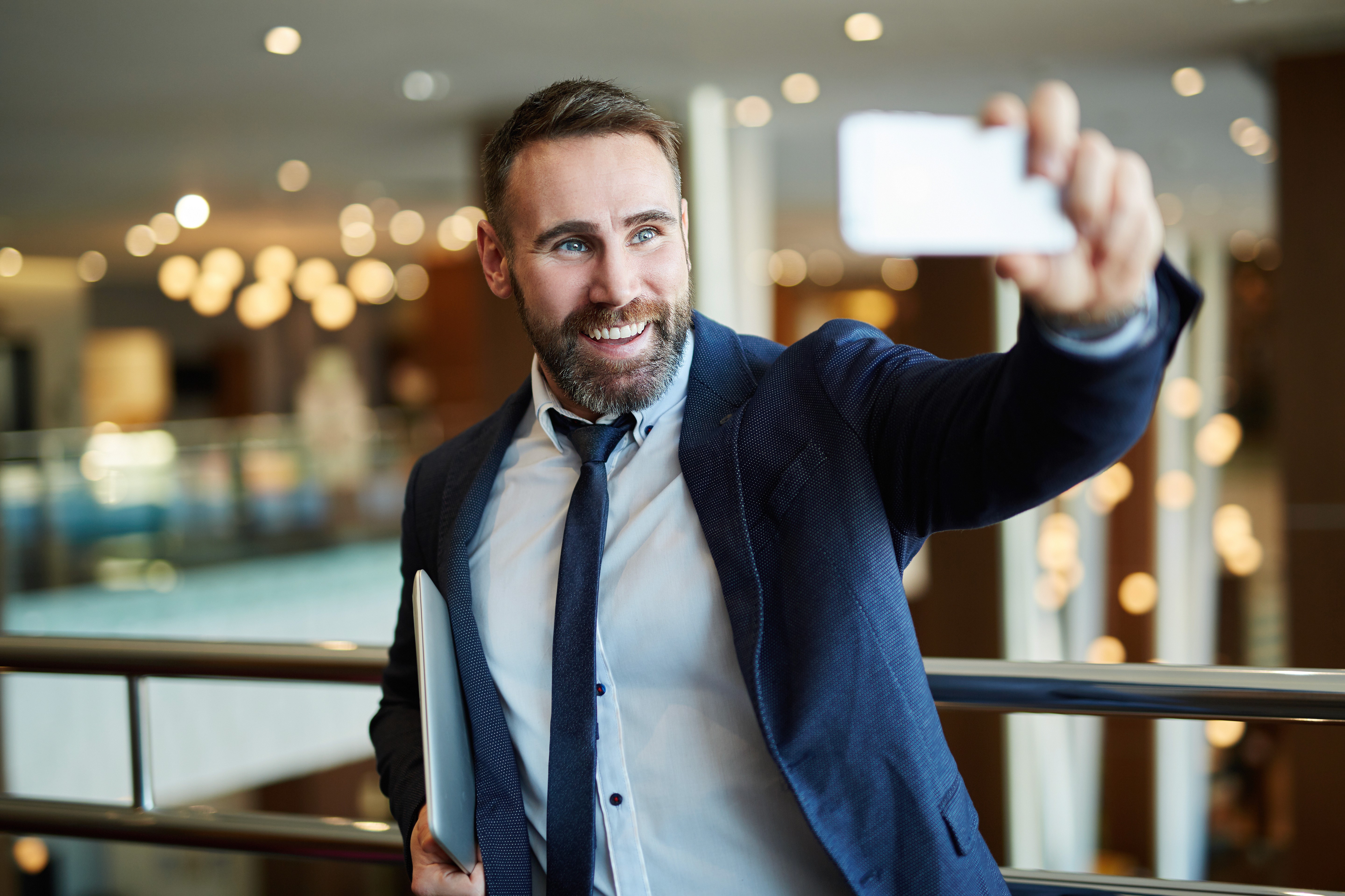 man-in suit-taking-selfie