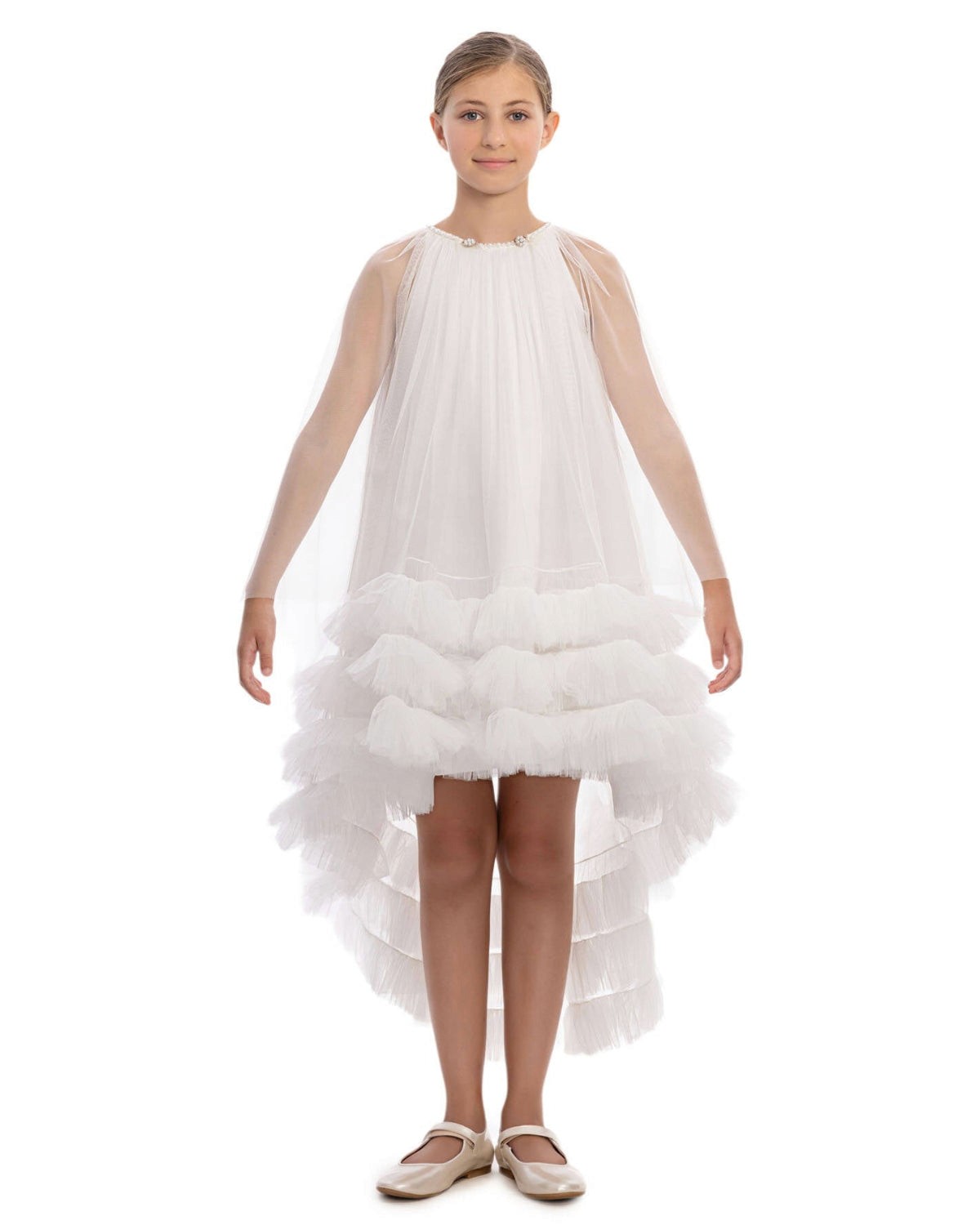 girl wearing a white dress with ruffled layers on a white background