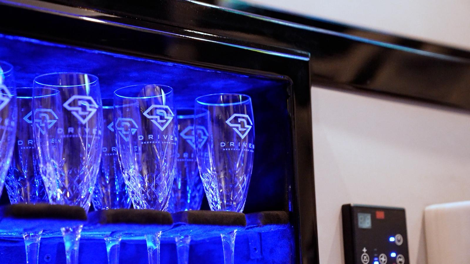 A cheerful car renter talking to an excited young child ready to drive a sportscar, ideal for car rental family moments.