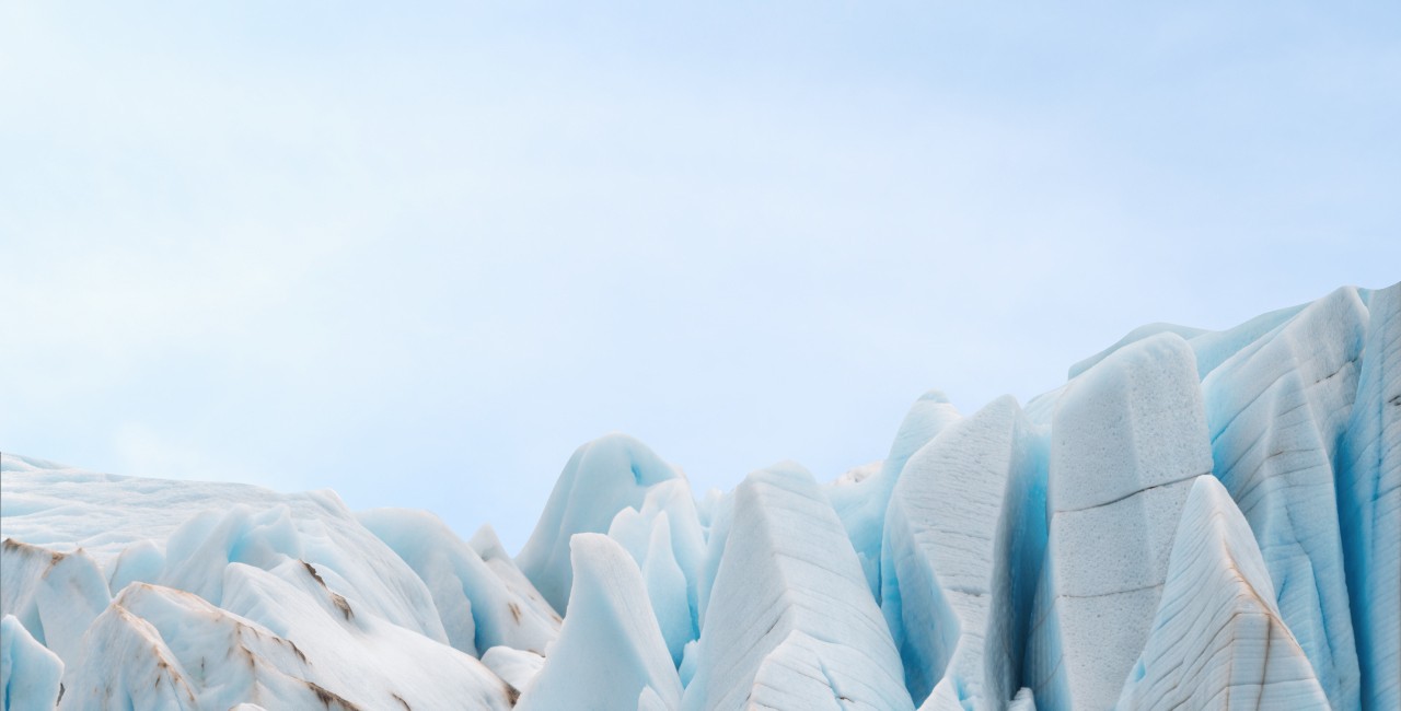 Stack of seracs - piles of glacial ice on the light blue background