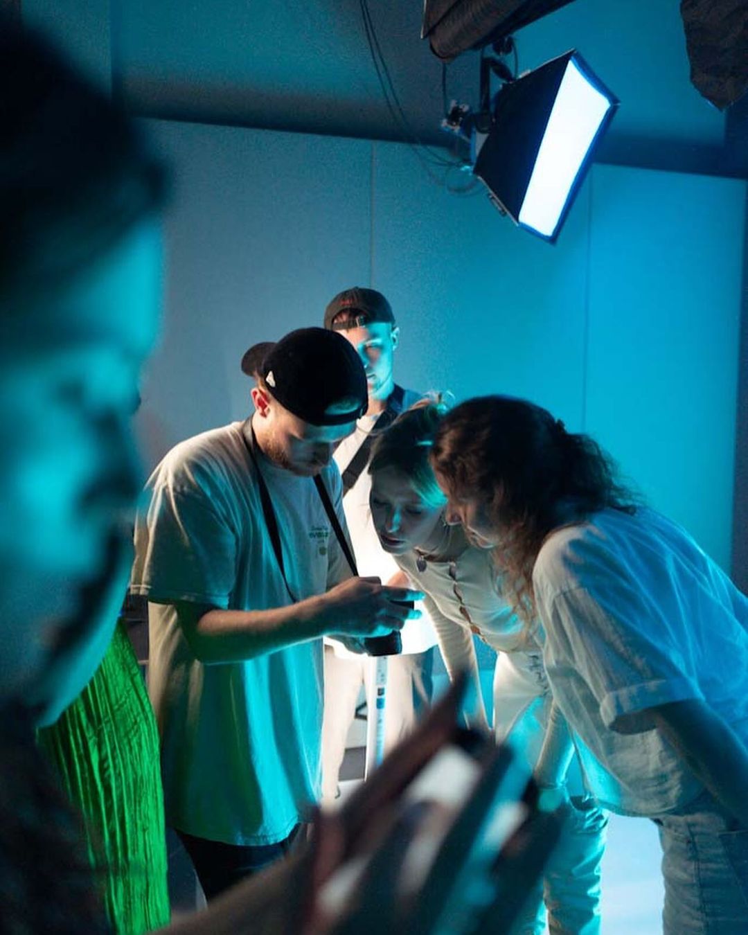 Team members in an office setting having a discussion, representing clear communication throughout the project process. musicvideo on lea in berlin sony studios