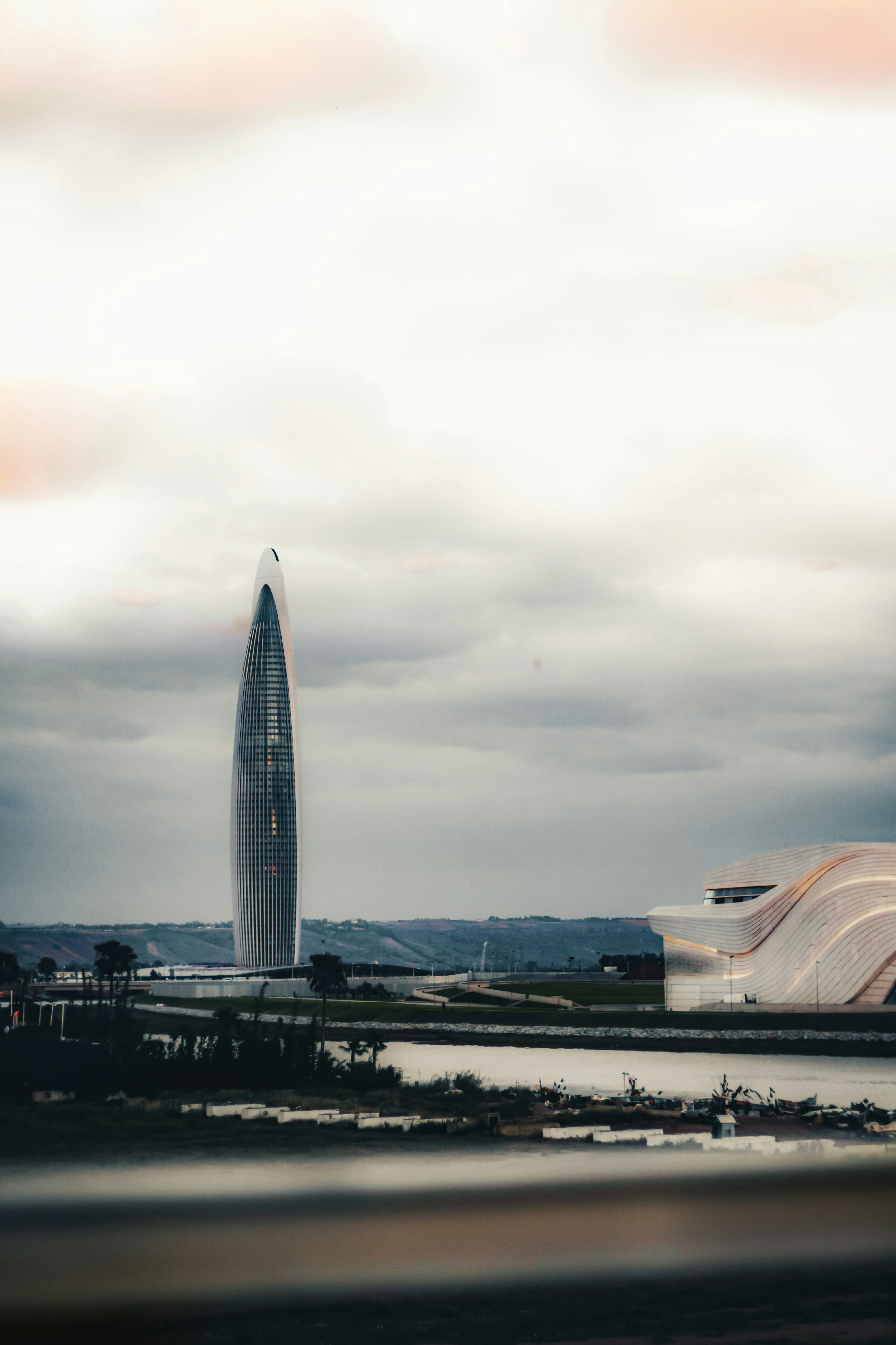 A large building with a very tall tower in the background