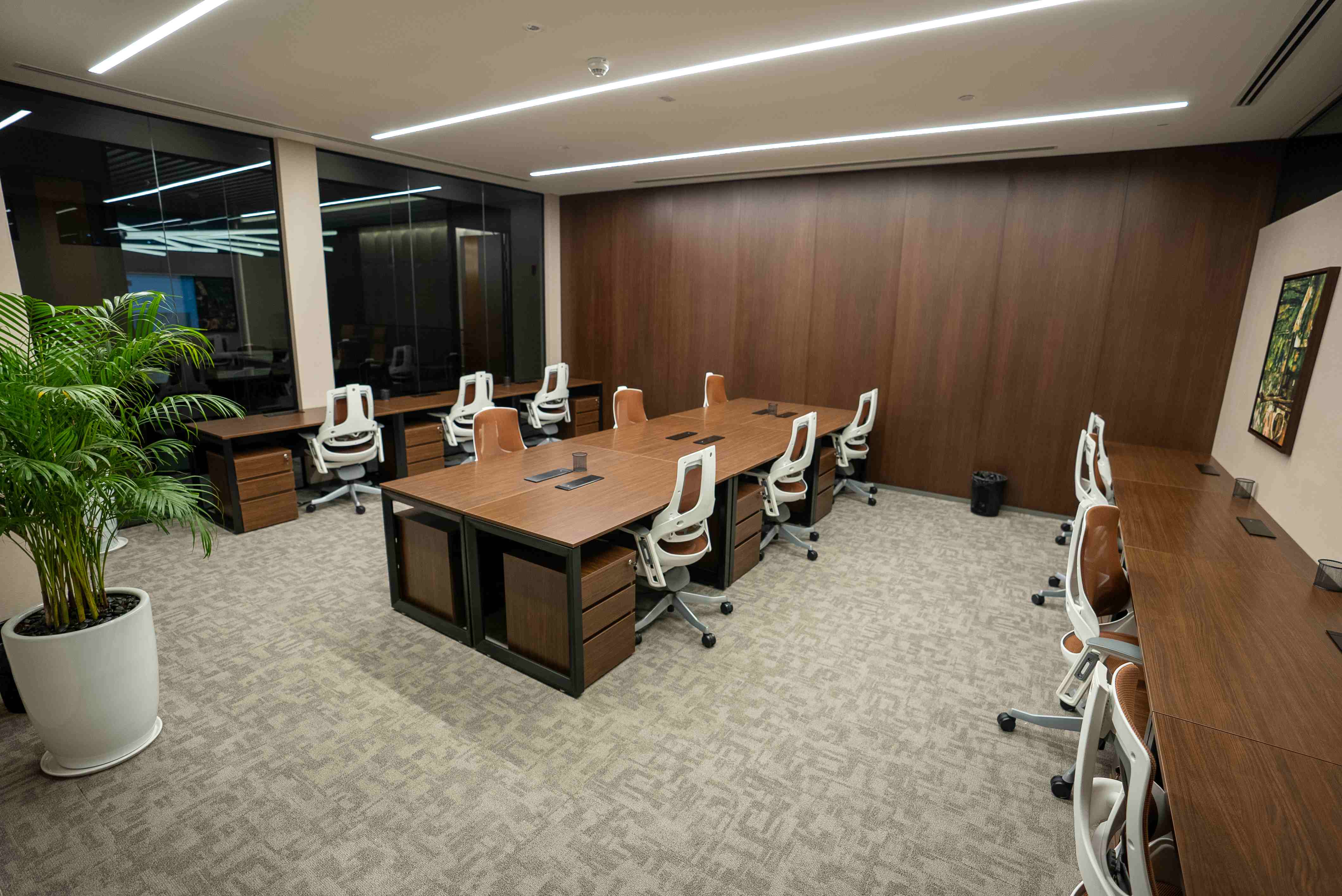 Coworking space at Nation Towers Mall featuring sleek wood interiors and modern ergonomic seating.