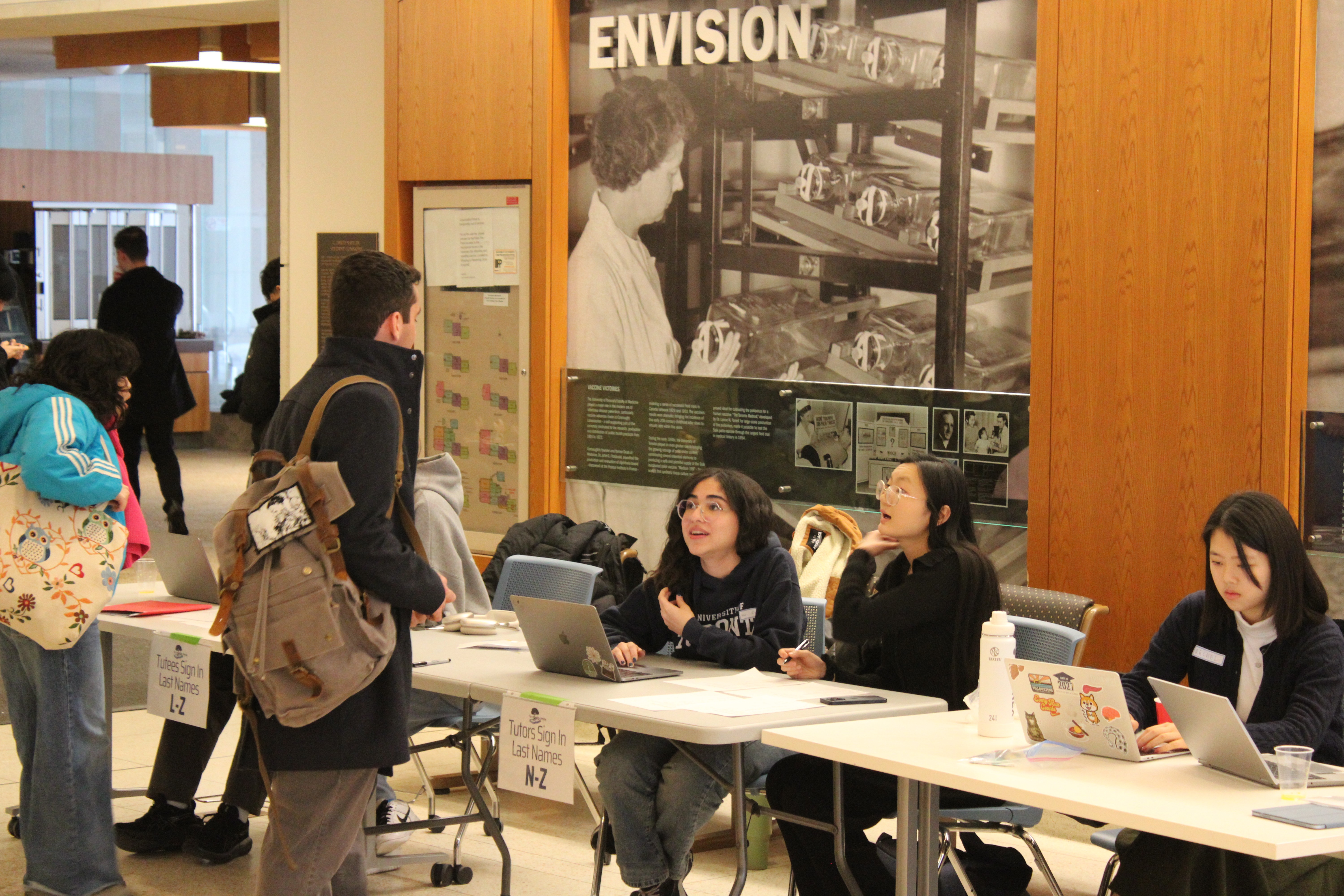 A green butterfly rests on a flower.