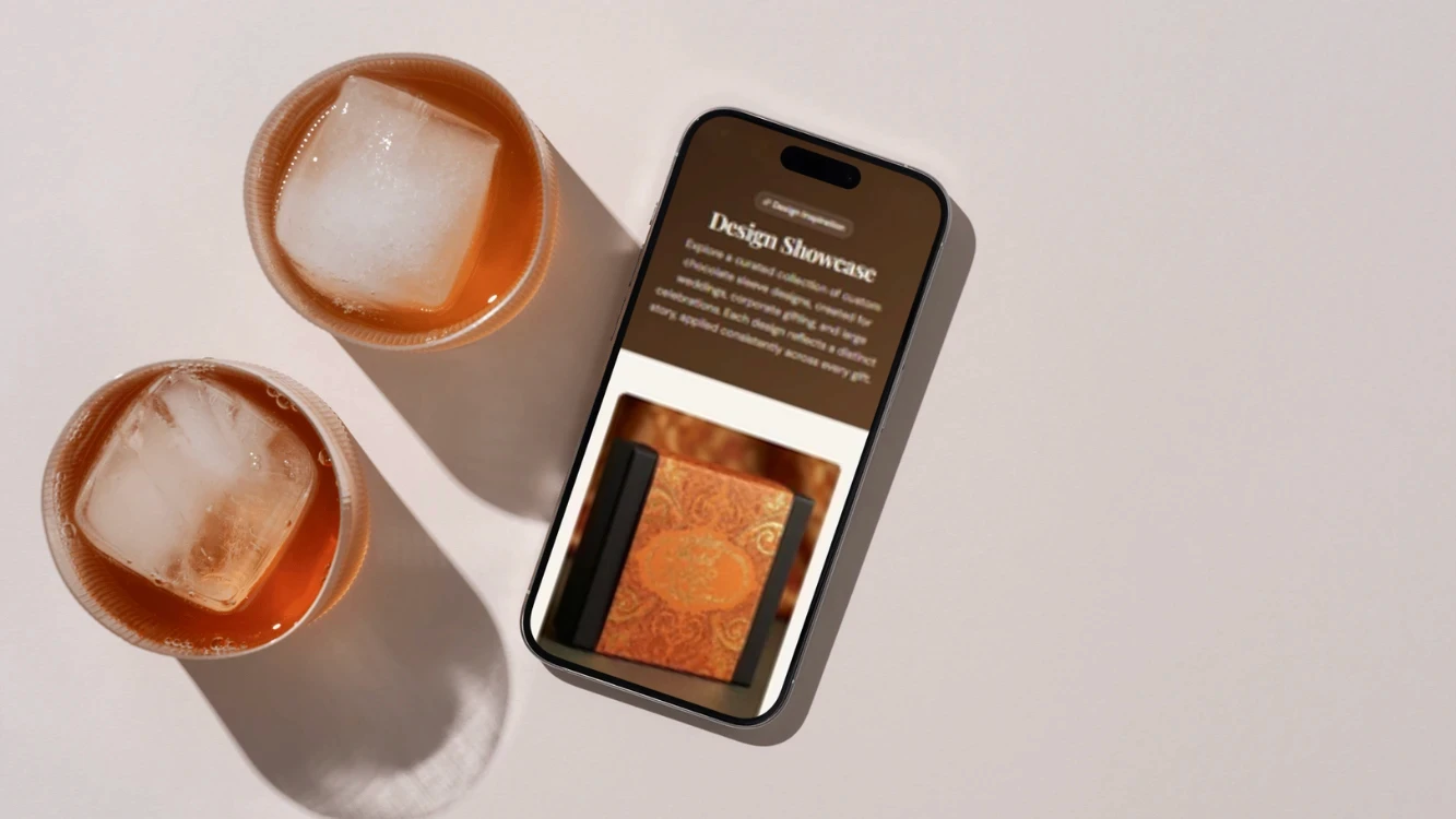 Smartphone displaying "Design Showcase" next to two iced drinks casting shadows.