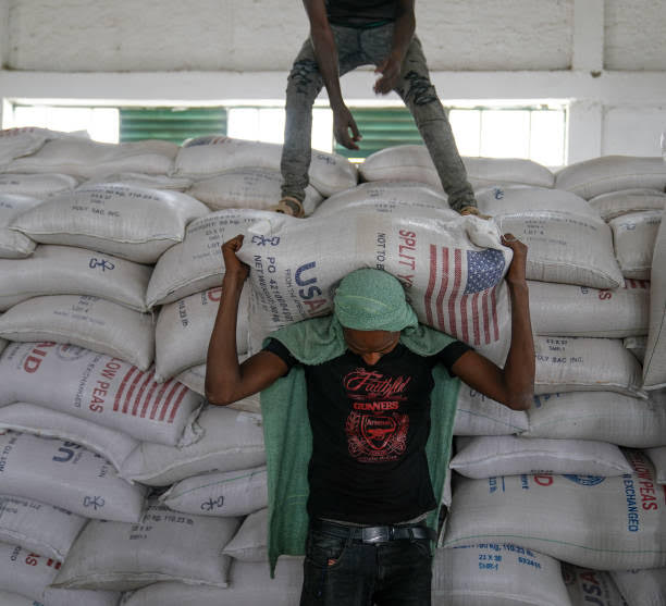 Man carrying bags of rice