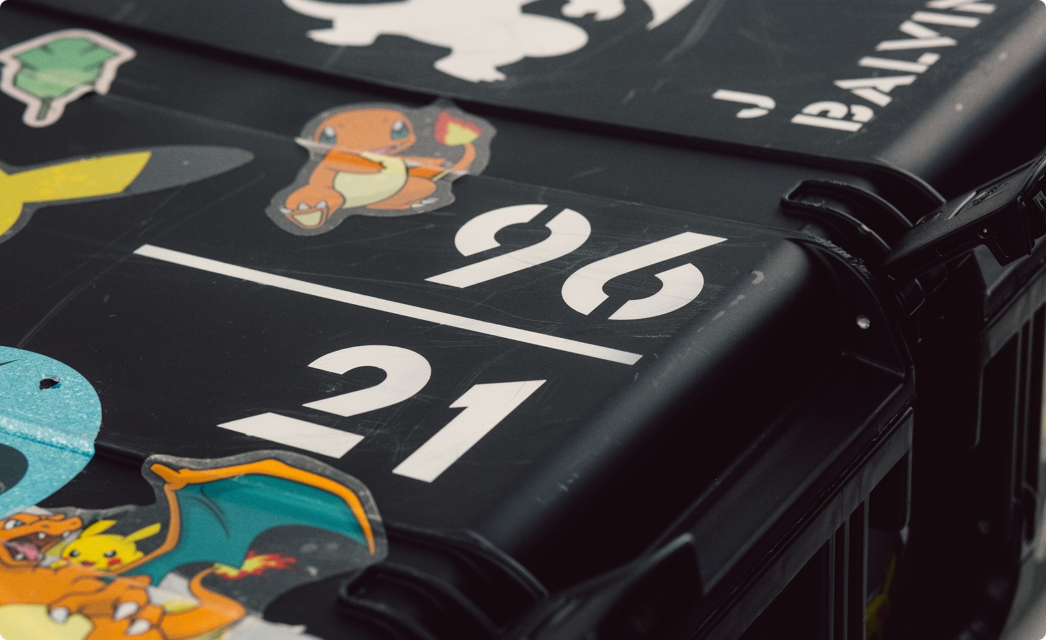A closeup of the numbers 96 21 stenciled on the distressed influencer kit case