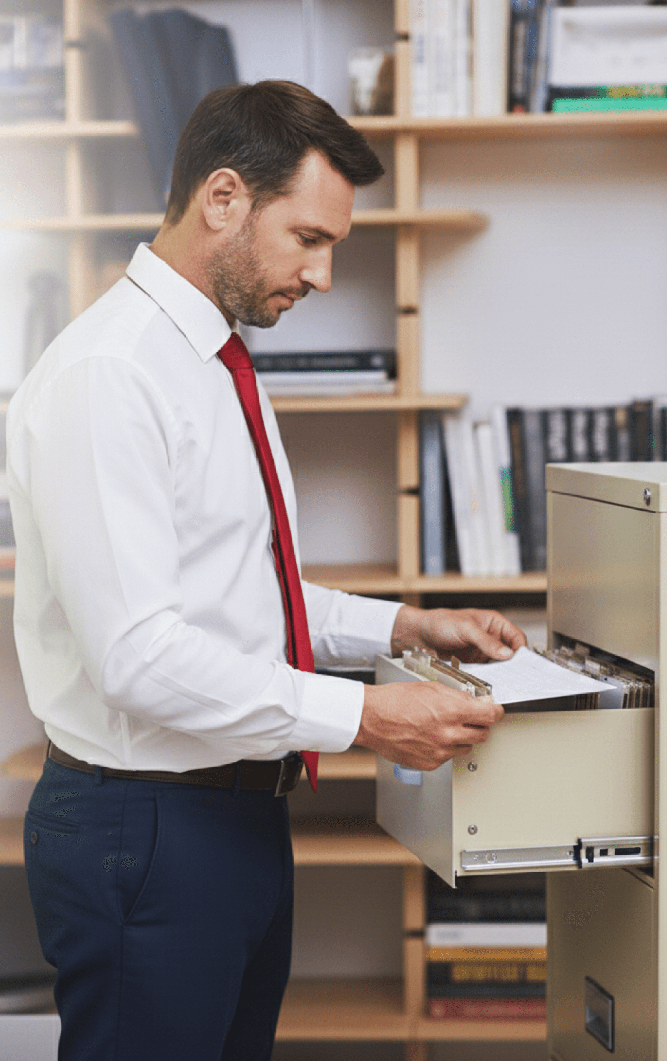 Corporate officer managing sensitive paper records to mitigate physical operational risks.