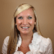 middle age white woman with blonde and white professional outfit
