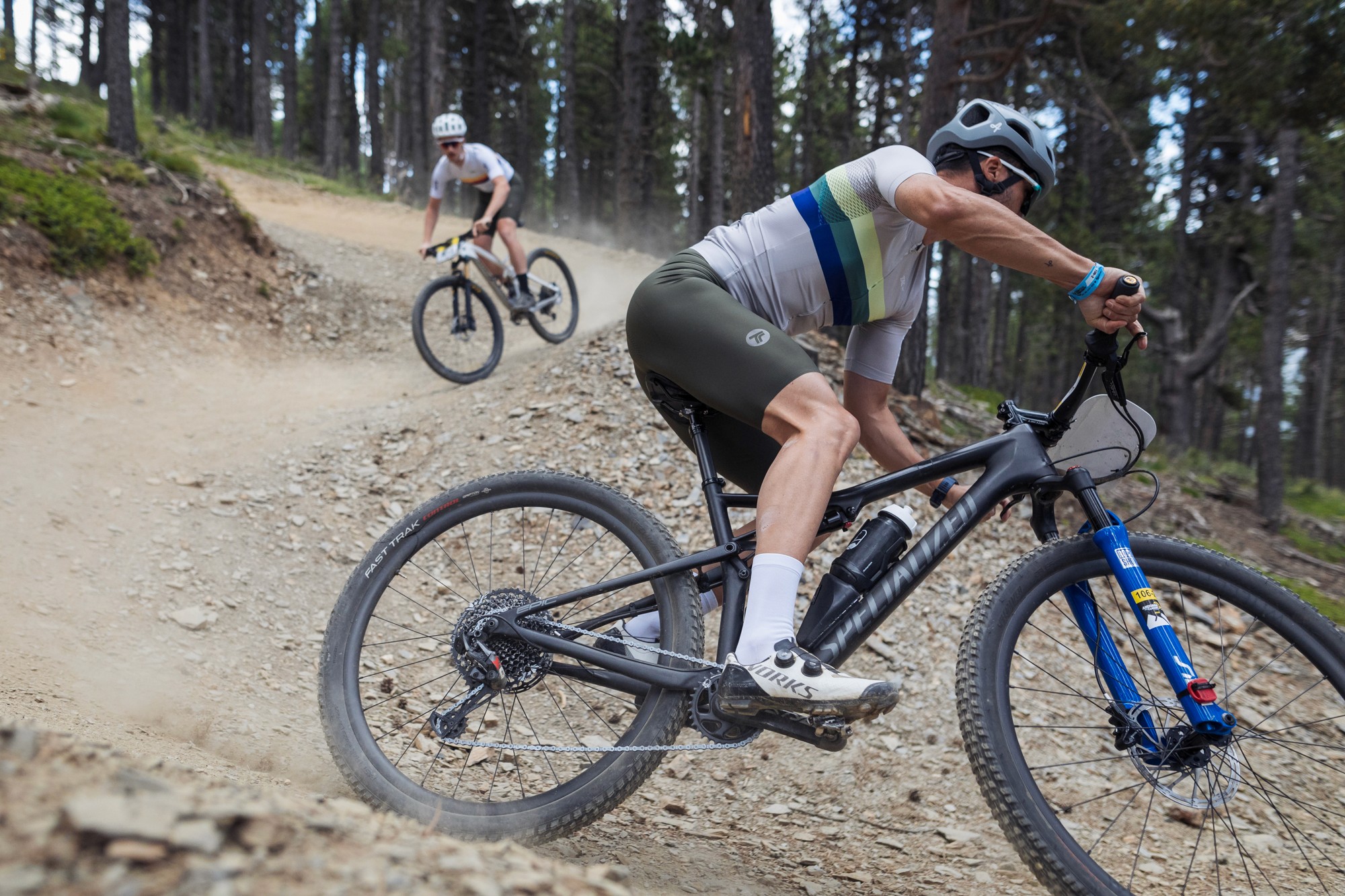 Two mountain bikers race down a twisting trail