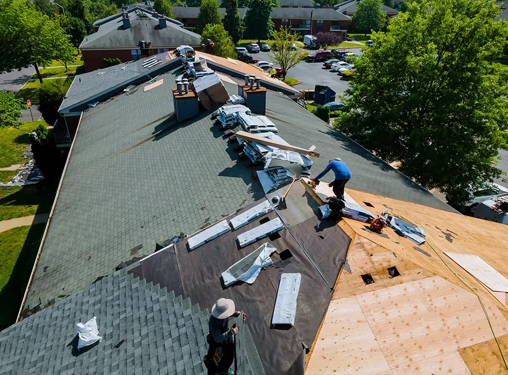 louisville roofing contractor nailing down asphalt shingles on a roof