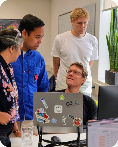 Colleagues gathered around a laptop