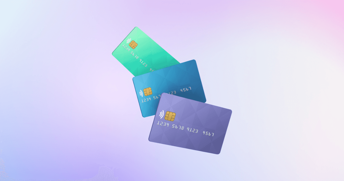 Three credit cards on a purple ombre background