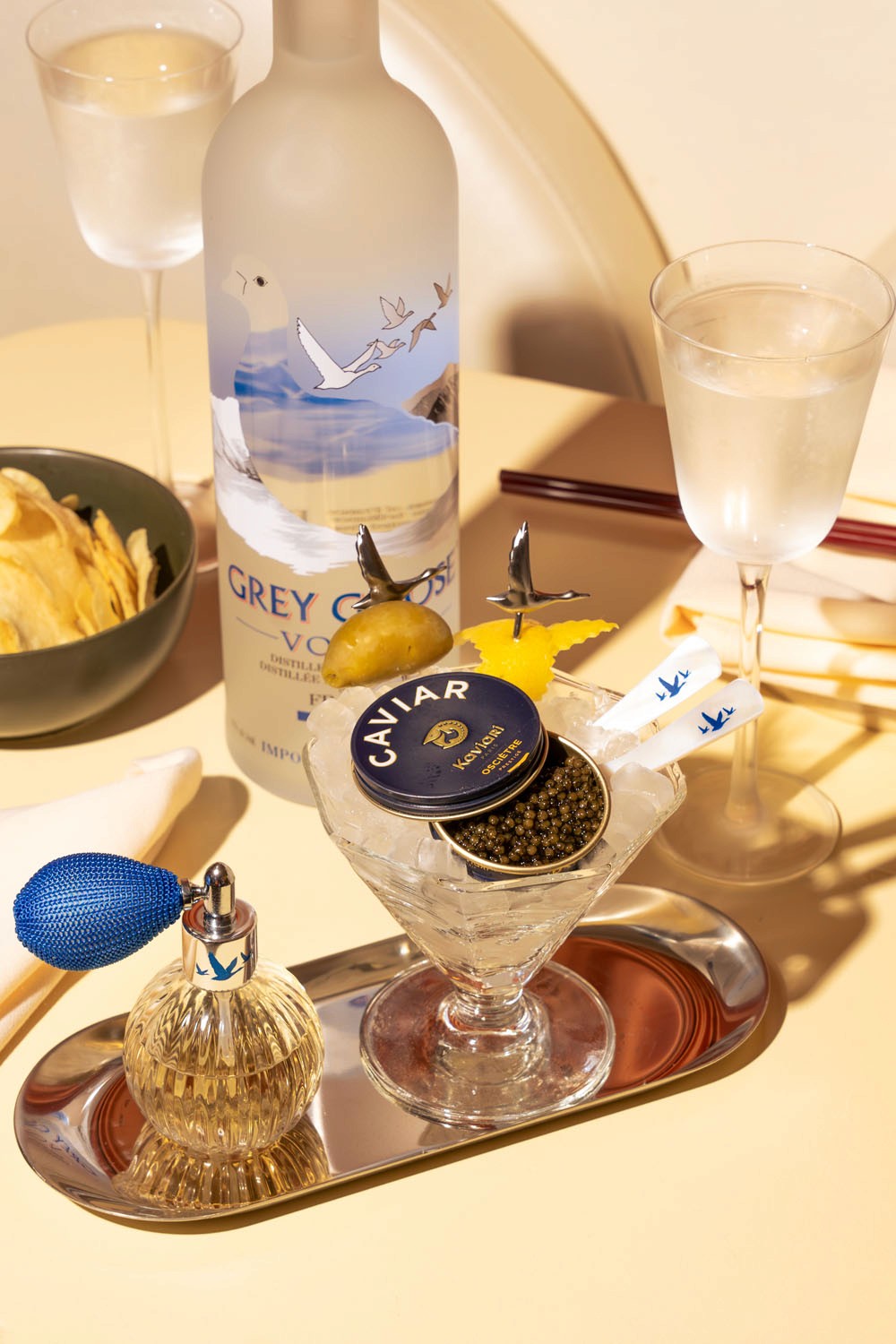 A luxurious still-life arrangement featuring Grey Goose vodka, a martini glass filled with caviar on ice, and elegant glassware, captured at Node Studio with a soft, sophisticated ambiance