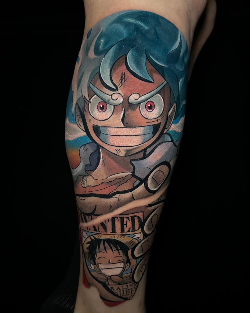 A vibrant tattoo of Gear 5 Luffy from One Piece, featuring his confident grin and iconic swirling hair, designed by Alan Pinks.