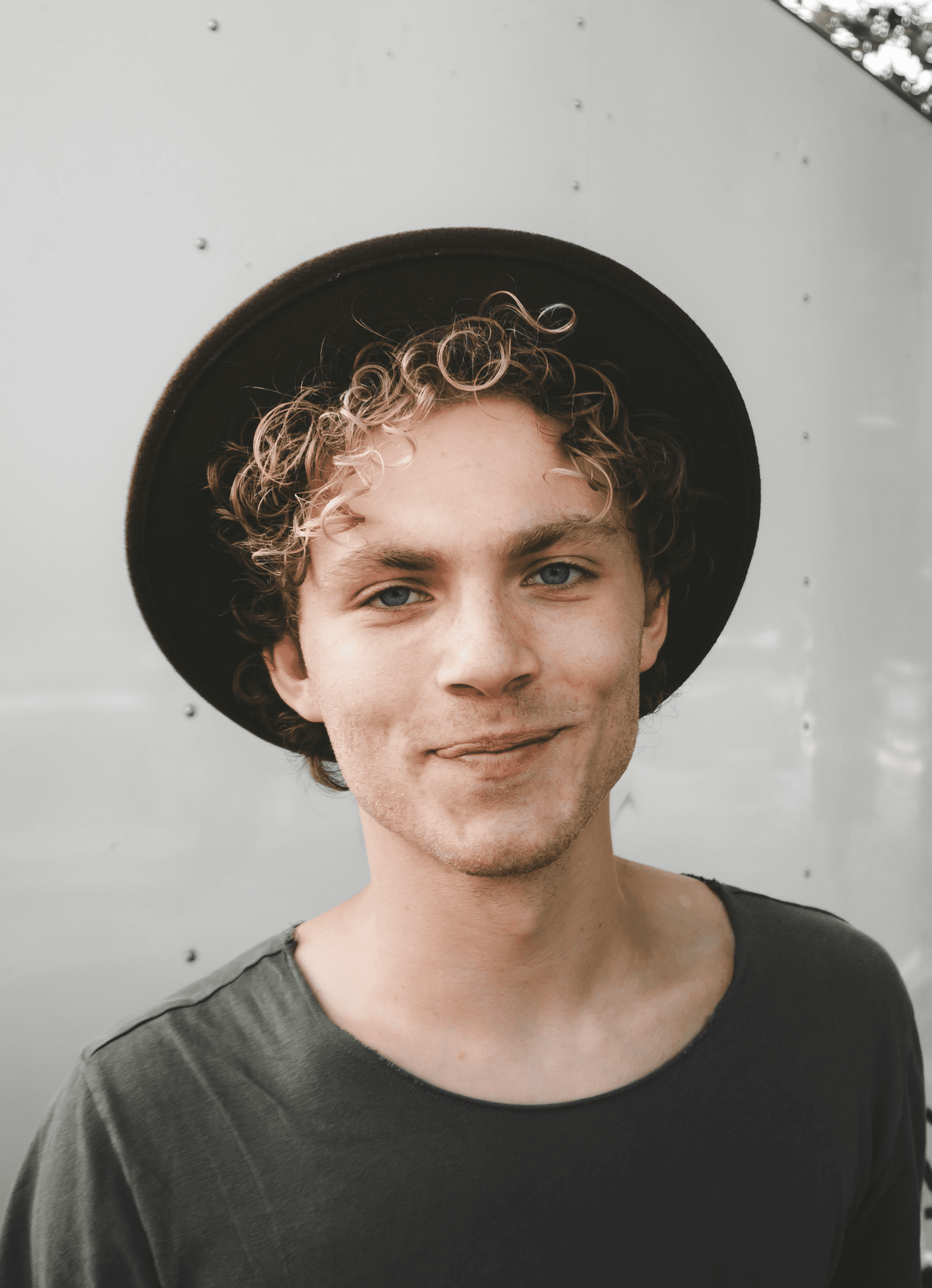 man standing near white wall