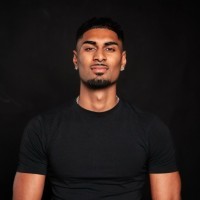 a man with a goatee smiles at the camera