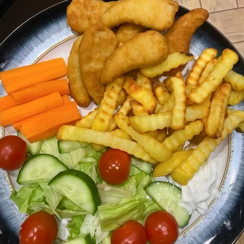 Top view of dinner, salad, fries, vegetarian nuggets