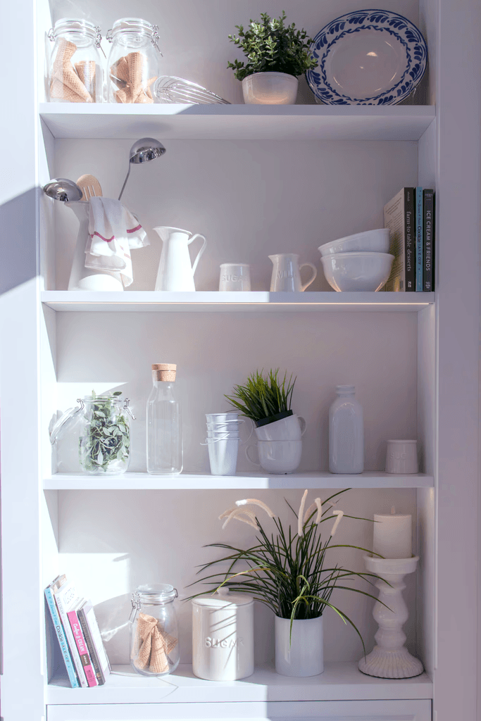 bowls and bottles in white wooden 4-layer shelf