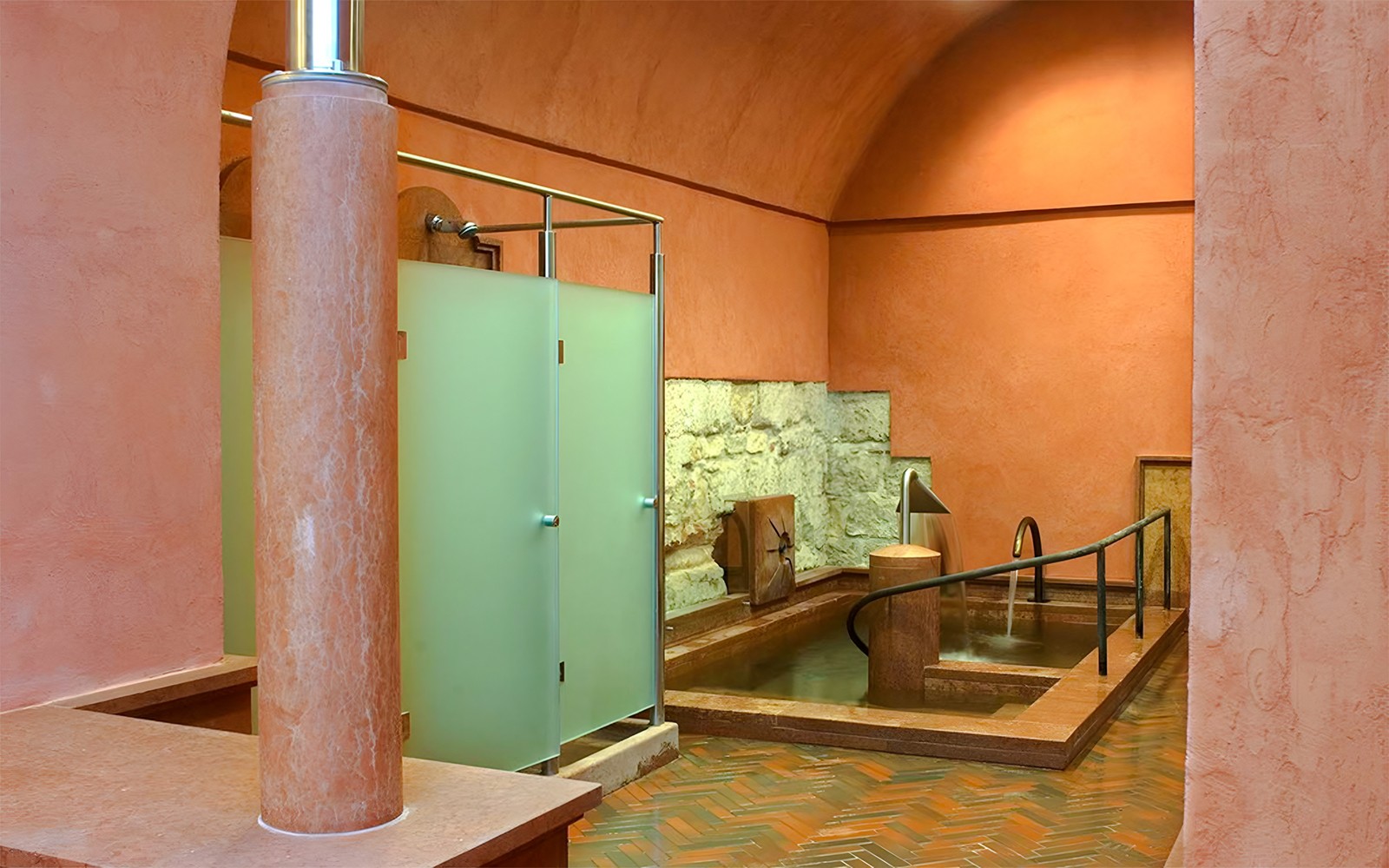 Rudas Thermal Spa interior with stone walls and a thermal pool.