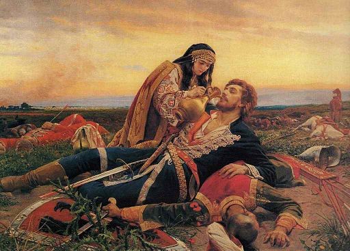 Two figures in a dramatic scene, one tending to the other amid a battlefield with a sunset in the background.