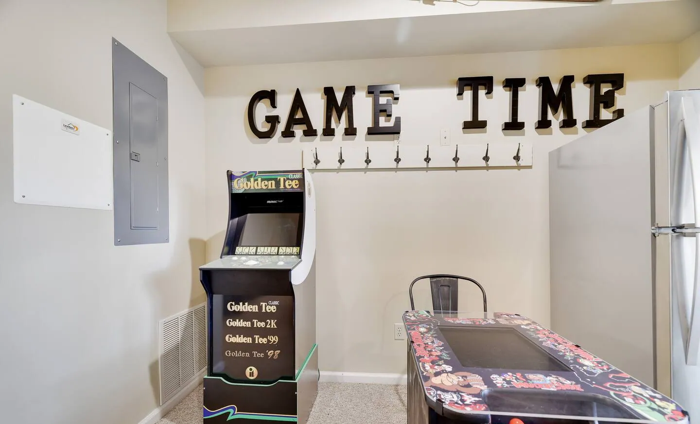 Golden Tee arcade cabinet and two-player arcade table at Mountainwoods Memories