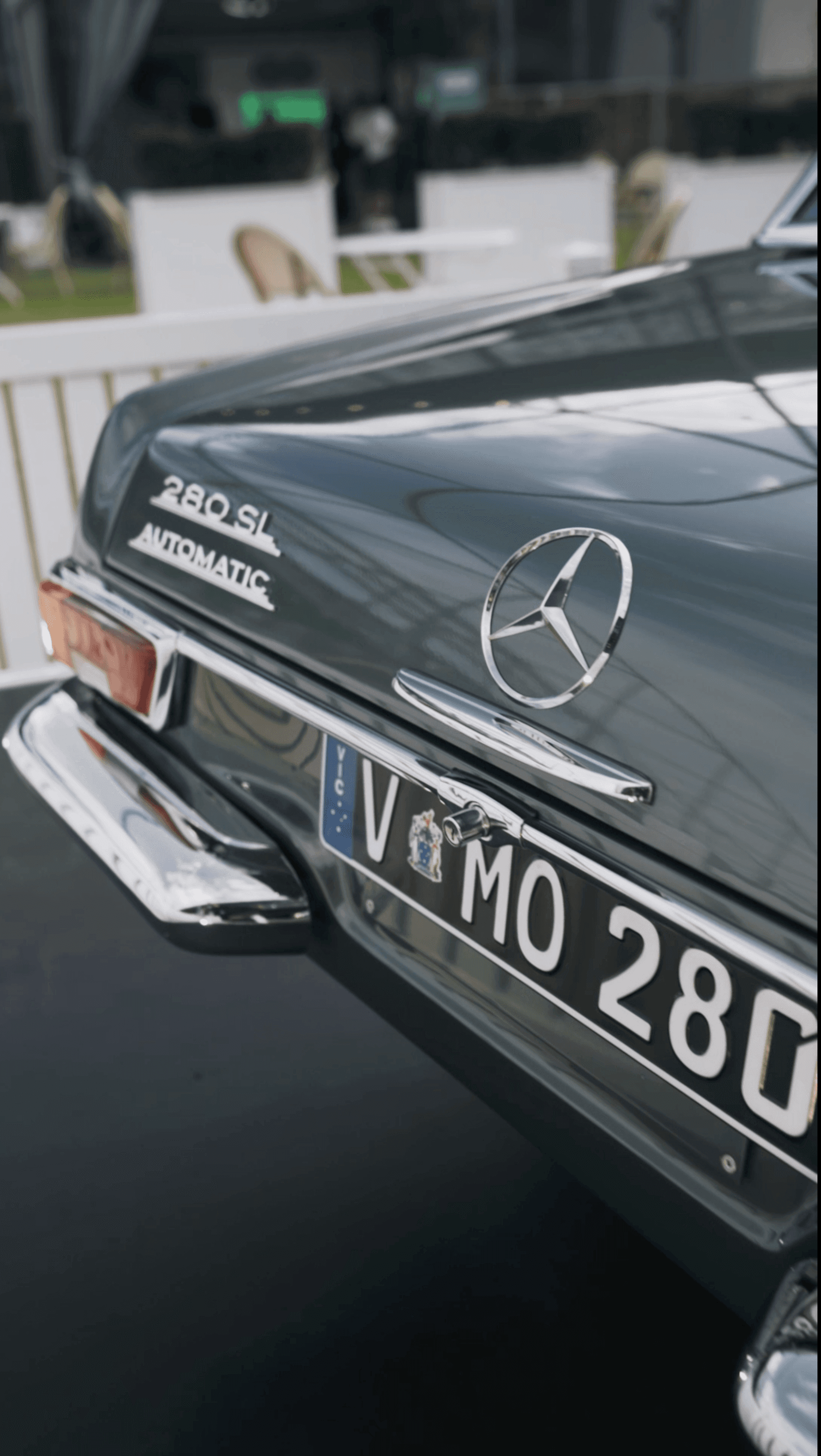 Close-up of the rear of a Mercedes-Benz car, showing part of the license plate and logo