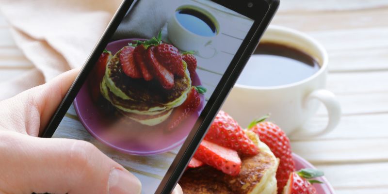 A Malaysian woman taking a photo of her food