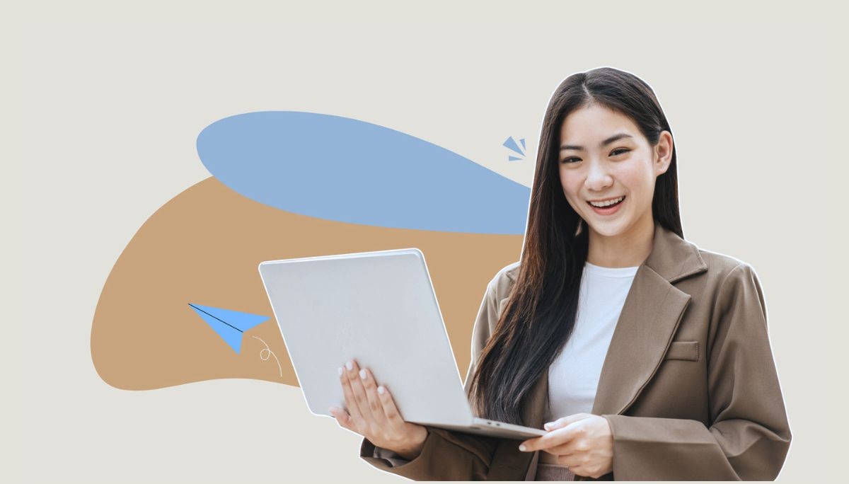 Person holding a laptop while wearing a blazer and white shirt, symbolizing business casual dress code for work and interviews.