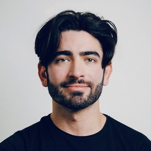 Black and white portrait of a man with a beard and glasses