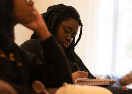 Woman making notes in the Life Group session