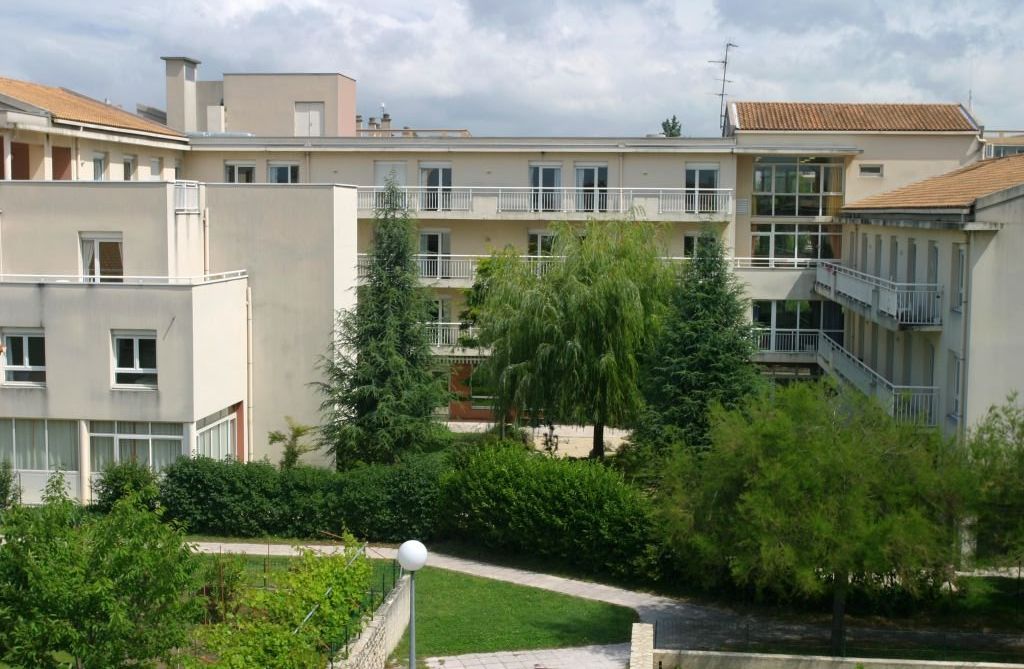 Full exterior view showing contemporary architecture	multiple wings	and well-maintained grounds