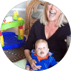 woman in black crew neck t-shirt wearing brown framed eyeglasses standing on rocky shore during