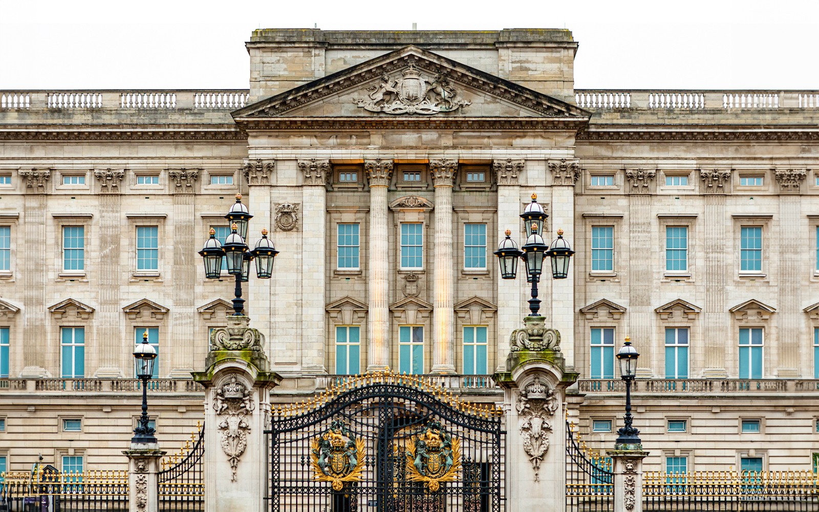Buckingham Palace exterior with tourists gathered for a guided tour in London.