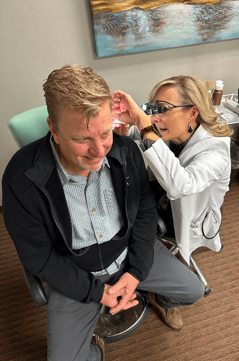 Old brick building with archways and windows.